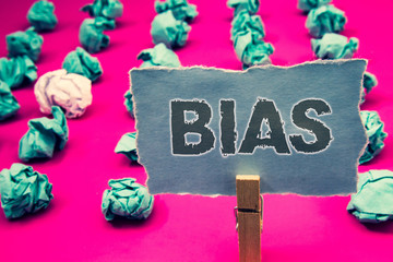 Handwriting text writing Bias. Concept meaning Unfair Subjective One-sidedness Preconception Inequality Bigotry Clothespin holding green paper crumpled papers ideas mistakes several tries