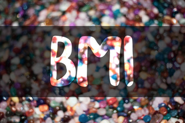 Text sign showing Bmi. Conceptual photo Body Mass Index determines healthy weight range with respect to height Blurry candies candy ideas message reflection sweets thoughts communicate