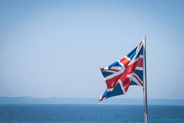 Fototapeta premium National flag of Great Britain at sea