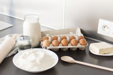 Food ingredients for baking: flour, eggs, milk, sugar. Process of baking.