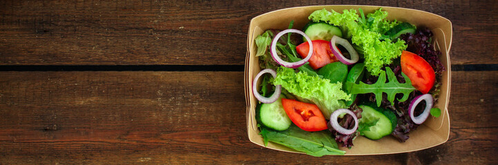 Healthy salad, leaves mix salad (mix micro greens, cucumber, tomato, onion, other ingredients) cutlery craft, rustic tableware. food background. copy space