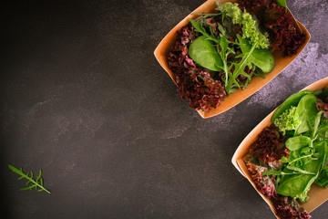 Healthy salad, leaves mix salad (mix micro greens, cucumber, tomato, onion, other ingredients) cutlery craft, rustic tableware. food background. copy space