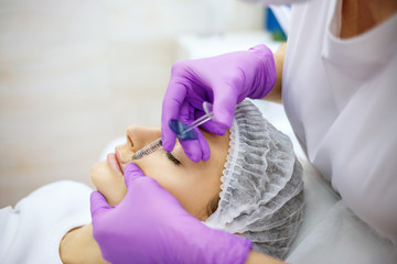 Beautiful woman on rejuvenation procedure in beauty clinic.