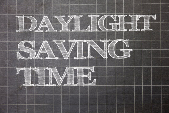 Writing note showing Daylight Sayving Time. Business photo showcasing advancing clocks during summer to save electricity Graph paper grey messages thoughts ideas information important math
