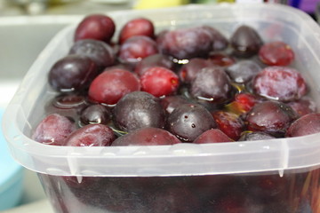 plums in water in a container