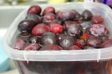 plums in water in a container