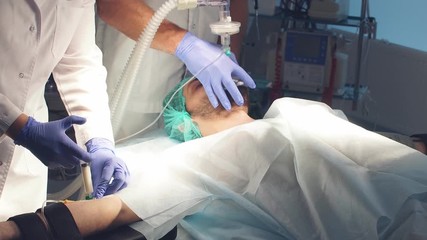 Male assistants prepares a patient to invasive surgery in the Hospital operating.