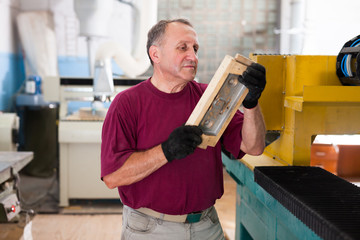 Foreman checks metal part on the wooden form