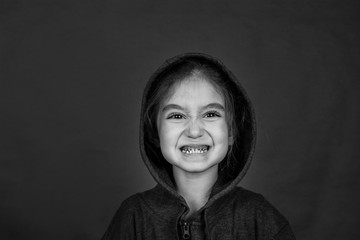 Shooting in the Studio. Portrait of a girl in a jacket with a hood.
