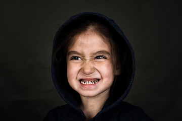 Shooting in the Studio. Portrait of a girl in a jacket with a hood.