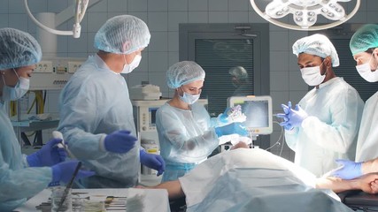 Group of professional surgeons at work in operating room. Emergency case, surgery, medical technology