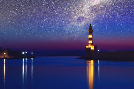 Galaxy over the Lighthouse of Chania at ummer sunset , Crete , Greece. Elements of this image furnished by NASA.