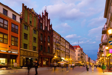 Fototapeta premium Night view of Torun streets and building illuminated at dusk