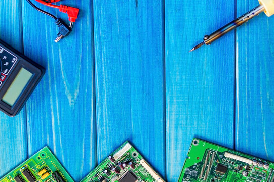 Services for the production of electronics and repair on a wooden blue background.