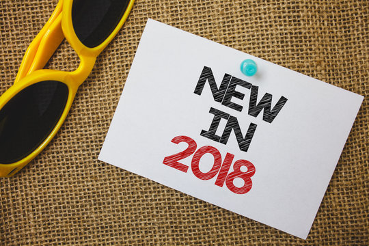 Writing note showing New In 2018. Business photo showcasing upcoming year resolution Advertising new product Specs Sunglass paper wonderful white background lovely message idea memories