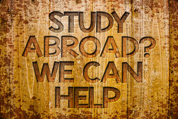 Conceptual hand writing showing Study Abroad Question We Can Help. Business photo showcasing going overseas complete your studies Wooden background wood colour beautiful templates message
