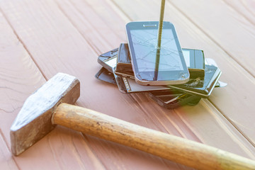 daylight. hammer hit on the phones. in one of them there is a metal nail