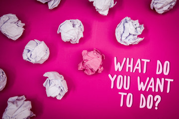 Conceptual hand writing showing What Do You Want To Do Question. Business photo text Meditate Relax Vacation Travel Desire Ideas pink background crumpled papers trial mistakes several tries