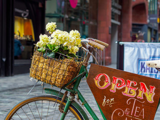 abstract bicycle in the back streets of Liverpool with flowers in the basket 