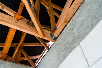 Roof trusses covered with a membrane on a detached house under construction, visible roof elements, battens, counter battens, rafters.