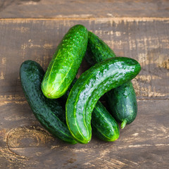 fresh cucumbers heap on wooden table top view