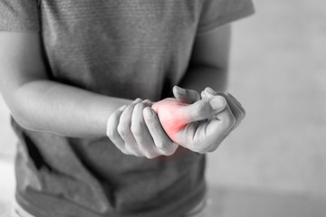 Young woman holding her wrist pain because using computer long time. De Quervain's tenosynovitis, Intersection Symptom, Carpal Tunnel Syndrome or Office syndrome.Disease and healthcare concept