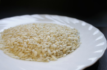 .rice in a white plate on a black background, isolated