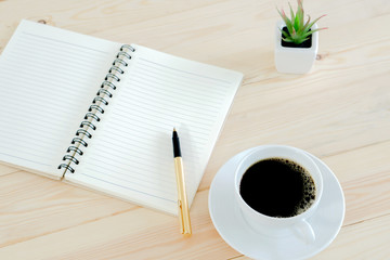 Open book with blank pages on wood background