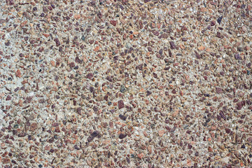 Concrete surface with small pebbles. Small stone wall texture for background.