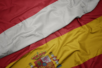 waving colorful flag of spain and national flag of indonesia.