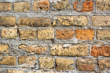 Weathered ancient red brick wall, antique medieval castle brick wall architecture orange brown decorative plaster aging medieval old bricks material