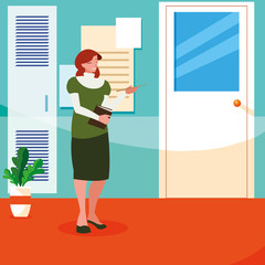 female teacher with textbook in corridor school