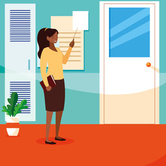 black female teacher with textbook in school corridor