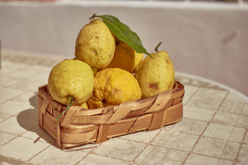 Obraz na płótnie Canvas Wicker basket full of lemons on the table.