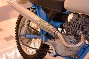 Motorcycle engine and exhaust pipe closeup. Retro bike shiny classic metal details