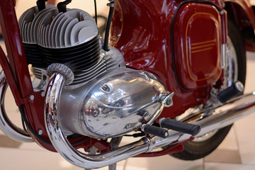 Motorcycle engine and exhaust pipe closeup. Retro bike shiny classic metal details