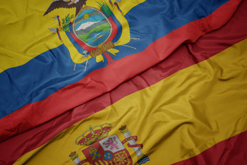 waving colorful flag of spain and national flag of ecuador.