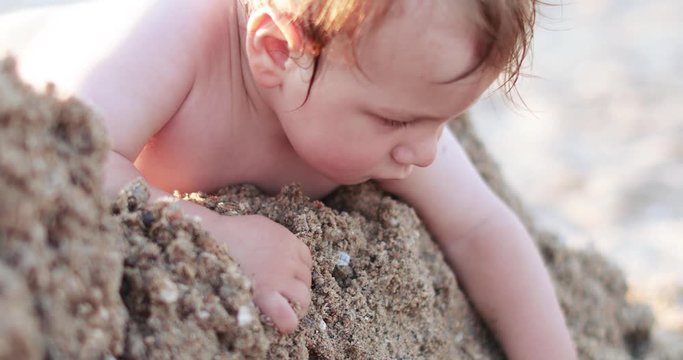 Child boy rowing sand