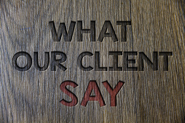 Writing note showing What Our Client Say. Business photo showcasing Customers Feedback or opinion about product service Wooden wood background black engraved letters ideas messages concepts