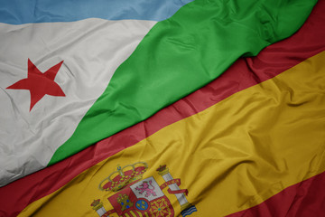 waving colorful flag of spain and national flag of djibouti.