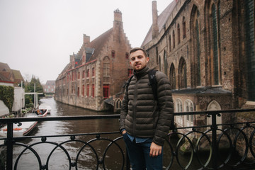 Young man walking in Belgium, Brugge. Male tourist