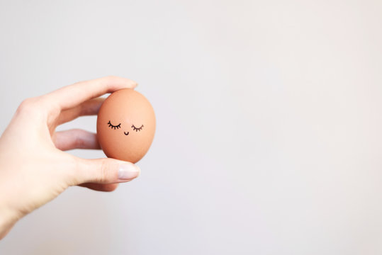 Woman holding egg with happy, funny and beautiful  face.