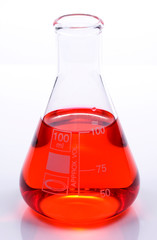 Scientific laboratory glass with red chemical liquid