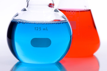 Scientific laboratory glass with blue and red chemical liquid
