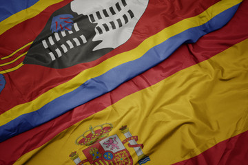 waving colorful flag of spain and national flag of swaziland.