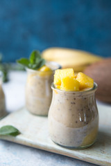 Beautiful and tasty dessert with mango and seeds of a chia. A fresh pudding with fruit for breakfast