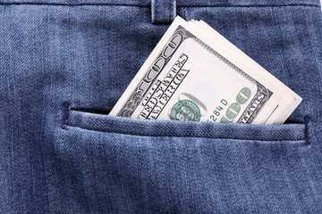 Closeup dollars in a jeans pocket