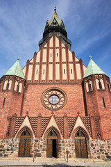 Fototapeta na wymiar facades of the neo-Gothic church with belfry in Poznan.