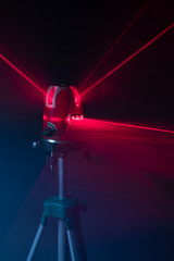 laser level tool red light beams, abstract background