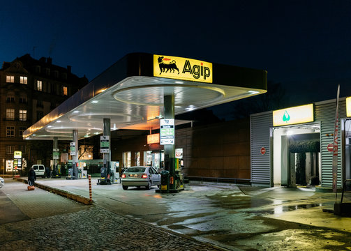 STRASBOURG, FRANCE - NOV 29, 2017: AGIP Gas station in France at night with people customers refueling cars. Agip is part of the ENI Group